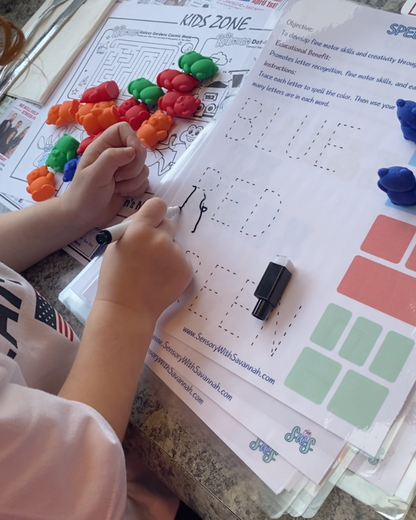 Toddler tracing words with Buddy Bears activity sheets and dry erase marker for early literacy skills.